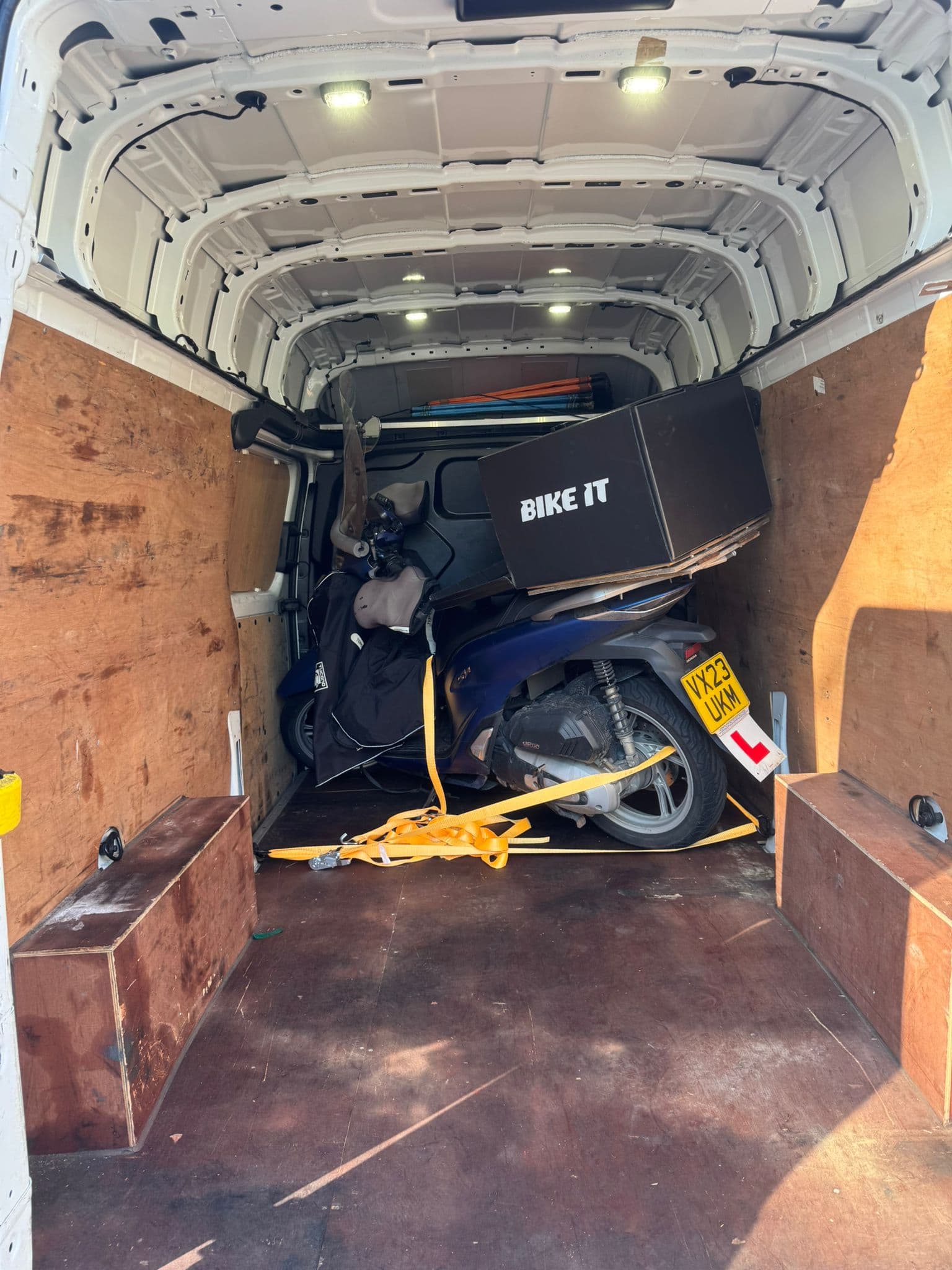 Motorcycle strapped down inside the van for pet-safe dedicated transport