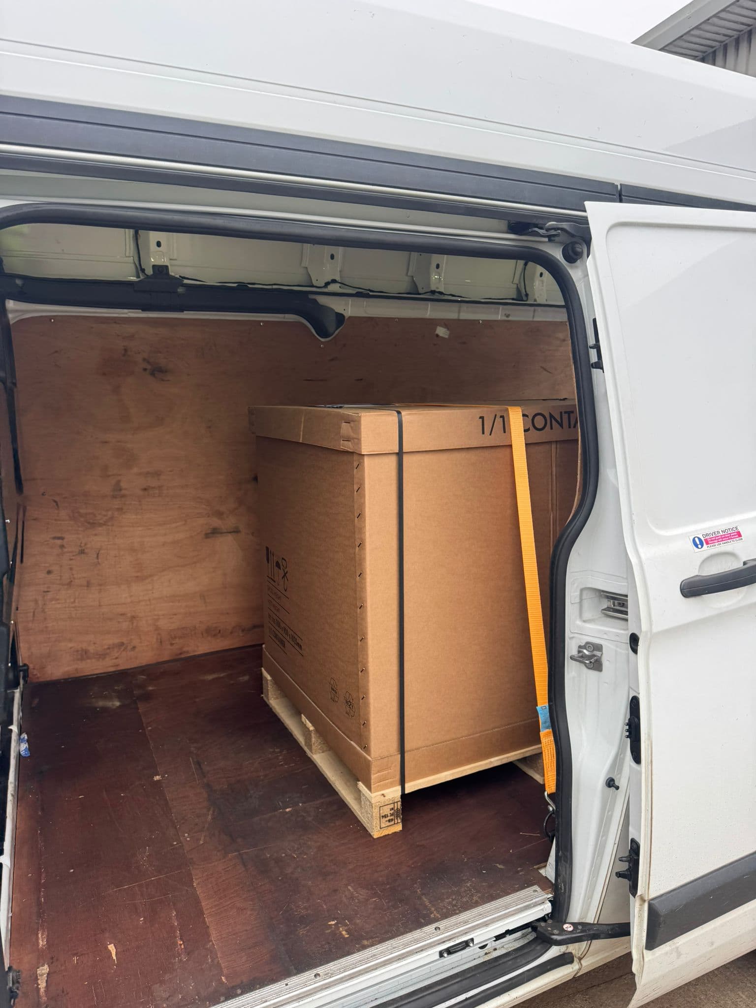 Pallet-mounted crate loaded through the side door