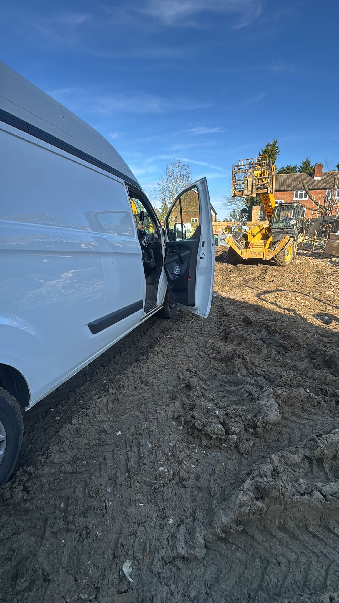 Van door open on a construction site — materials and site moves