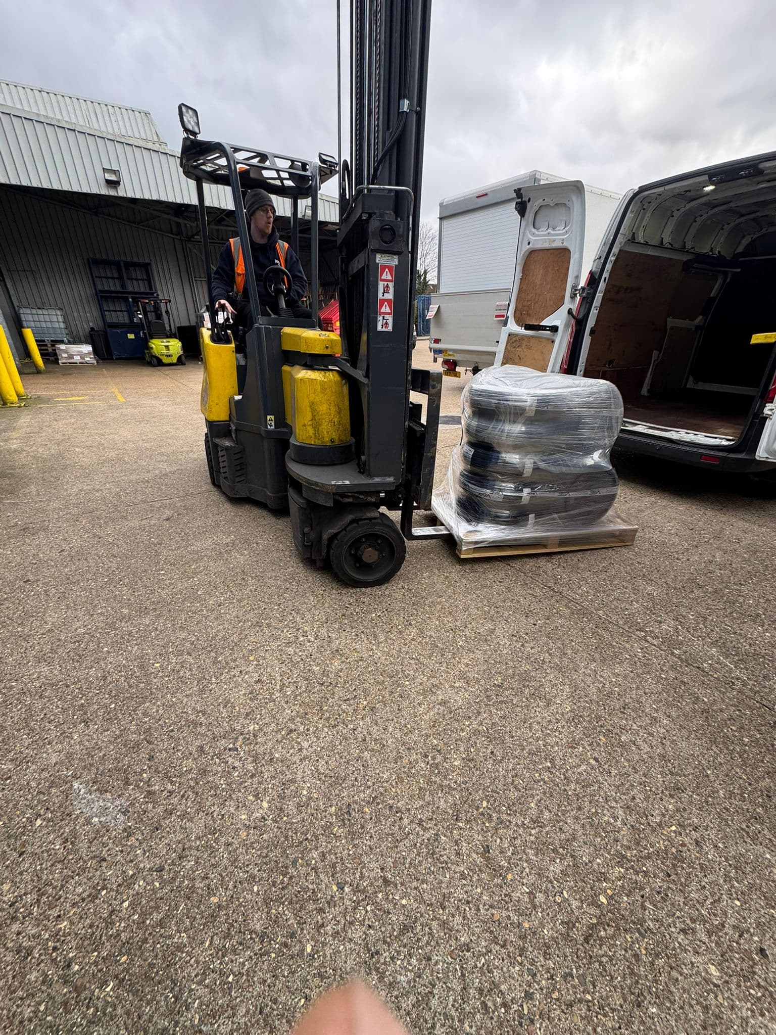 Forklift loading a pallet of tyres into a Gonsil Courier van