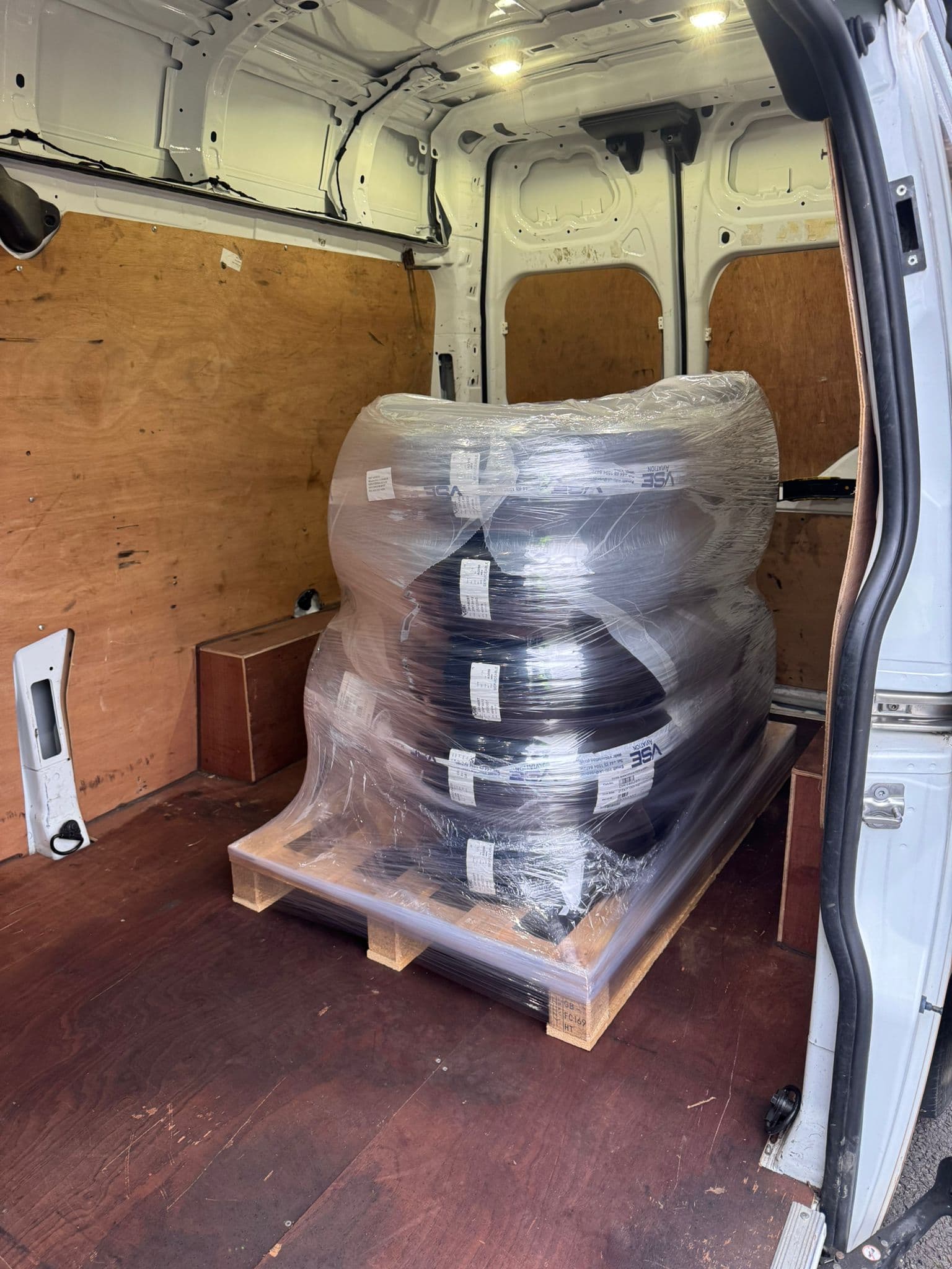 Shrink-wrapped pallet of tyres centred in the load bay